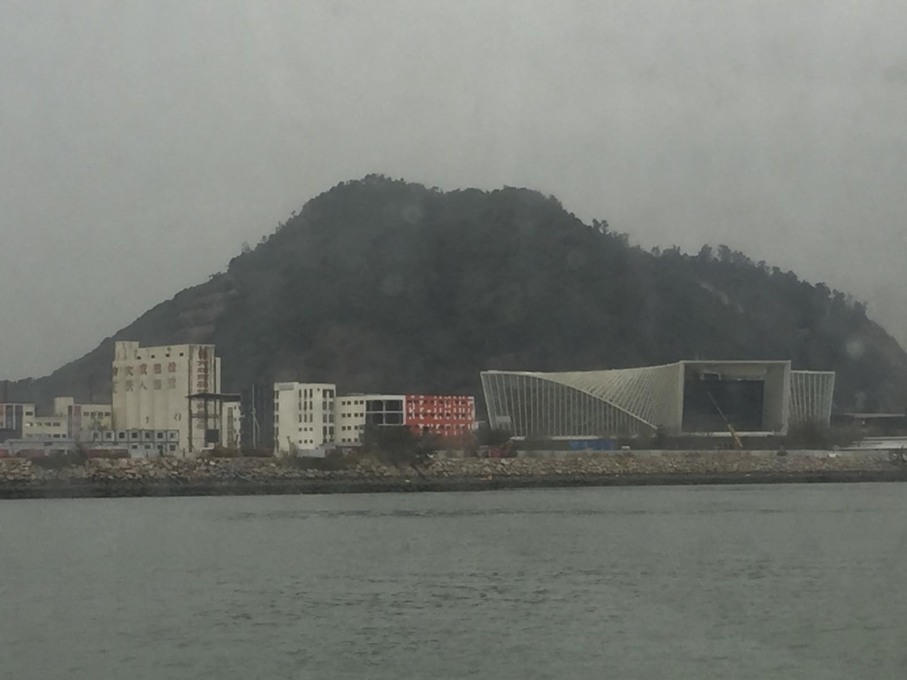 The Dacheng Flour Factory site of the Biennale, as seen from the ferry from Hong Kong, dwarfed by the China Merchants&rsquo; marketing pavilion to the right. (Photo: Rob Wilson)